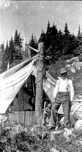 Harry Horstman and a tent [on Sproatt Mountain?]