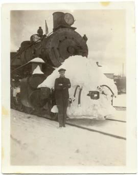 Reg Shurie in front of a P.G.E. steam train