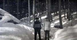 Two men standing in the snow