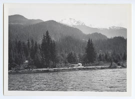 Helicopter on Landing Pad Beside Lake